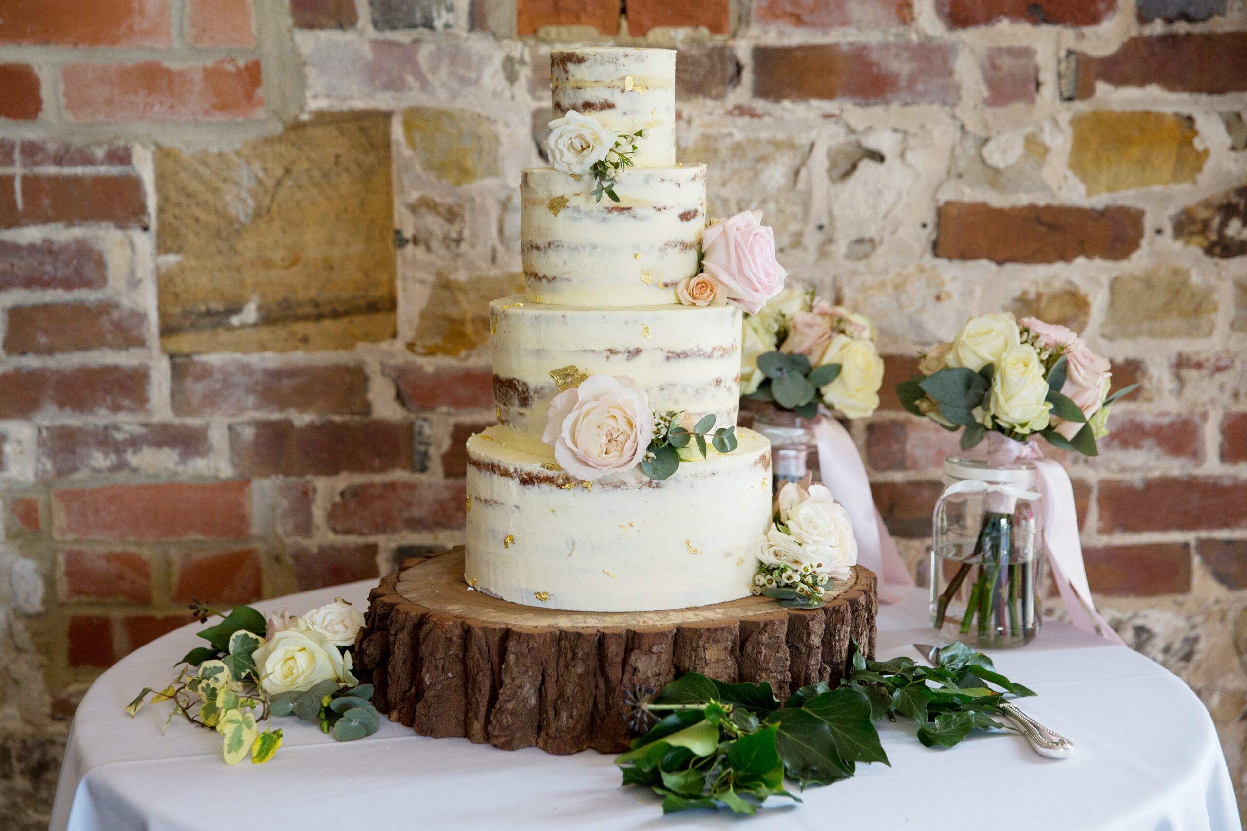 Sussex Cake Maker - Purple Flour 4 tiered semi-naked cake by Purple Flour